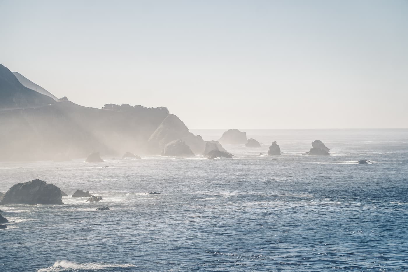 Misty sea stacks along the Big Sur coast in pale morning light