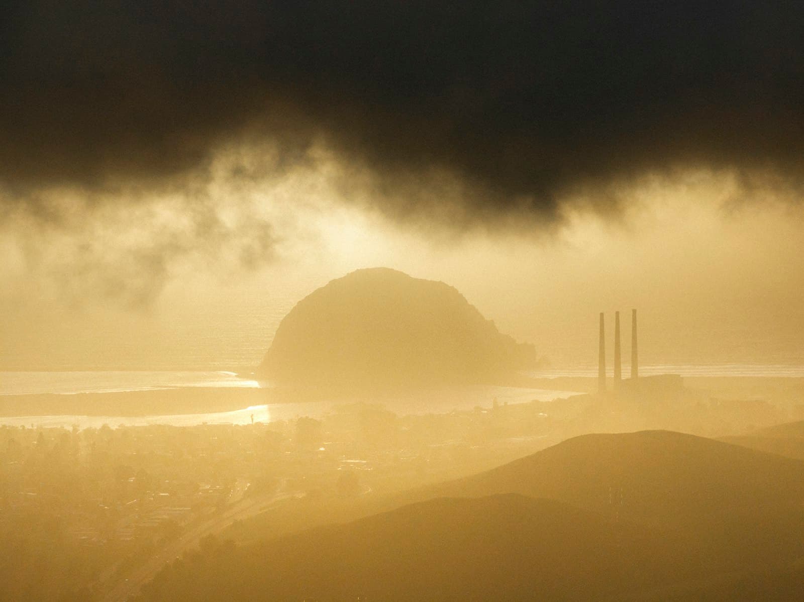 Morro Bay under golden evening fog, seen from the hills